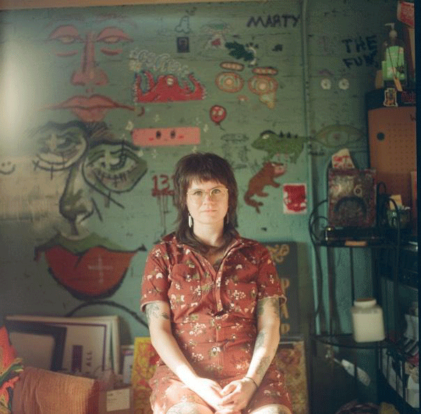 Artist sitting in chair has a haze from the film used