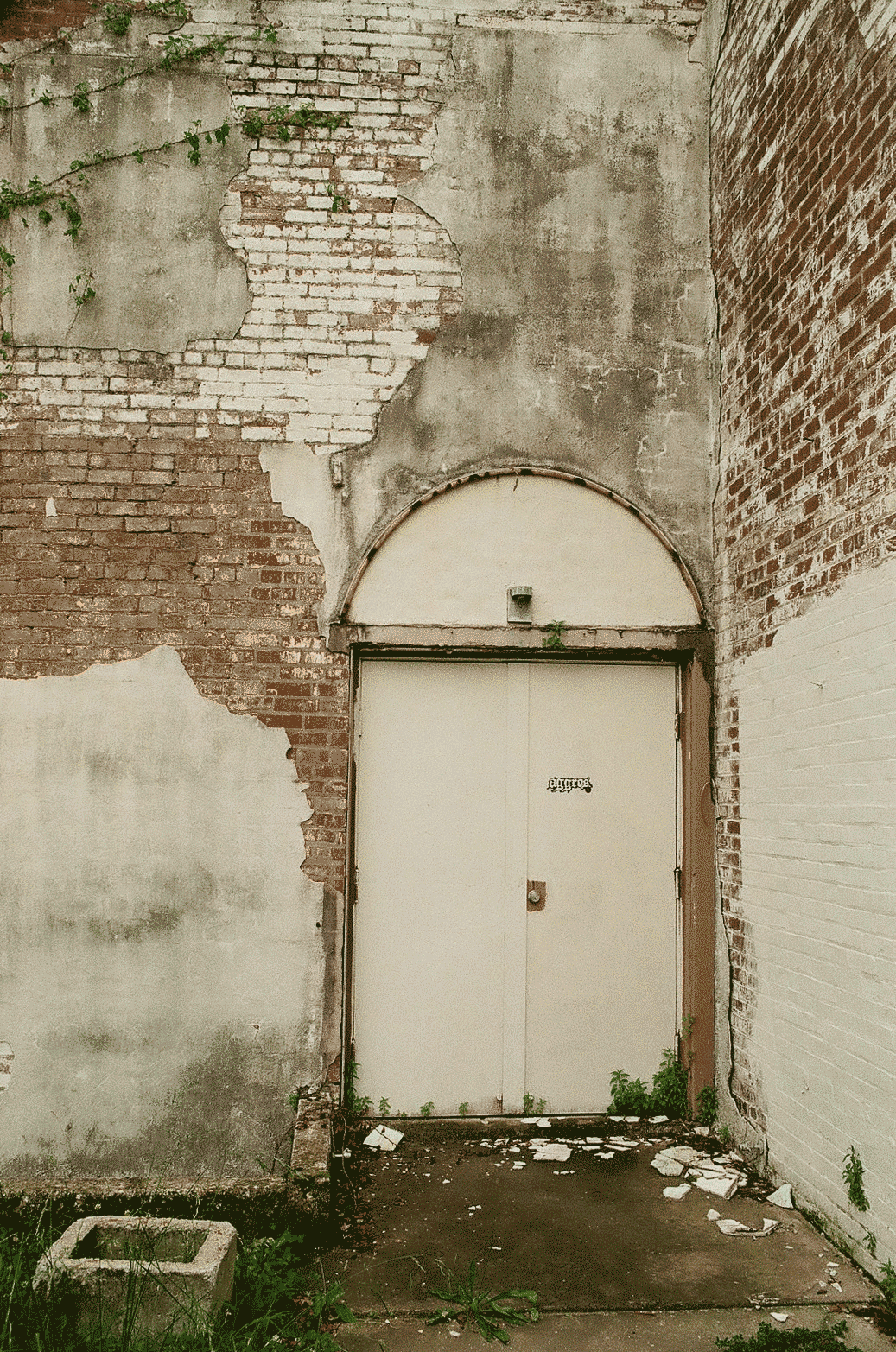 Door with cracking plaster around it