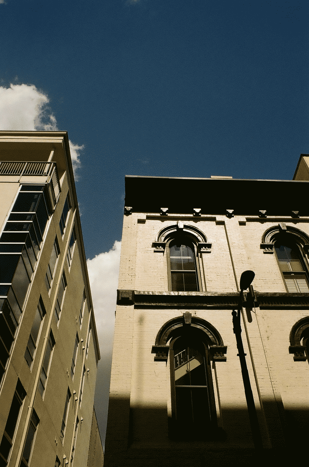 Two buildings photographed from below